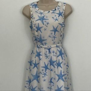 White mini dress with blue starfish.